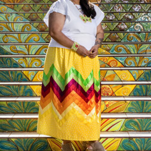 A woman in a colorful skirt